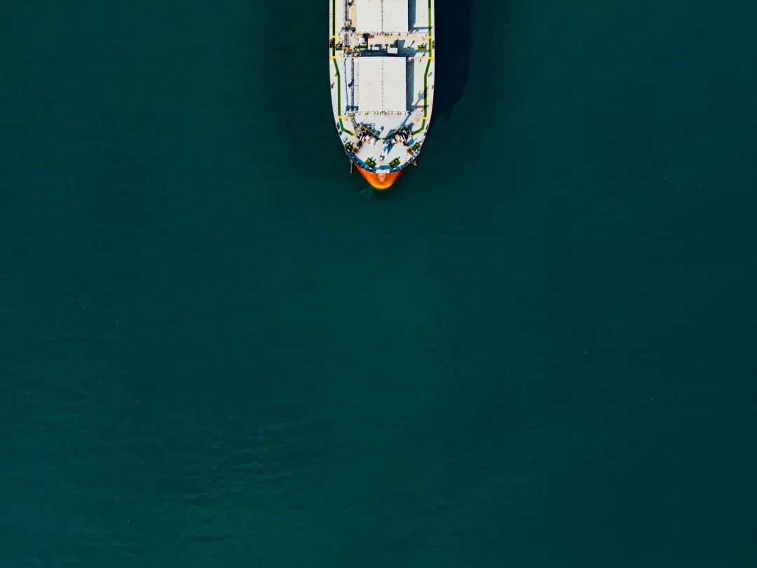 an aerial view of a boat in a body of water